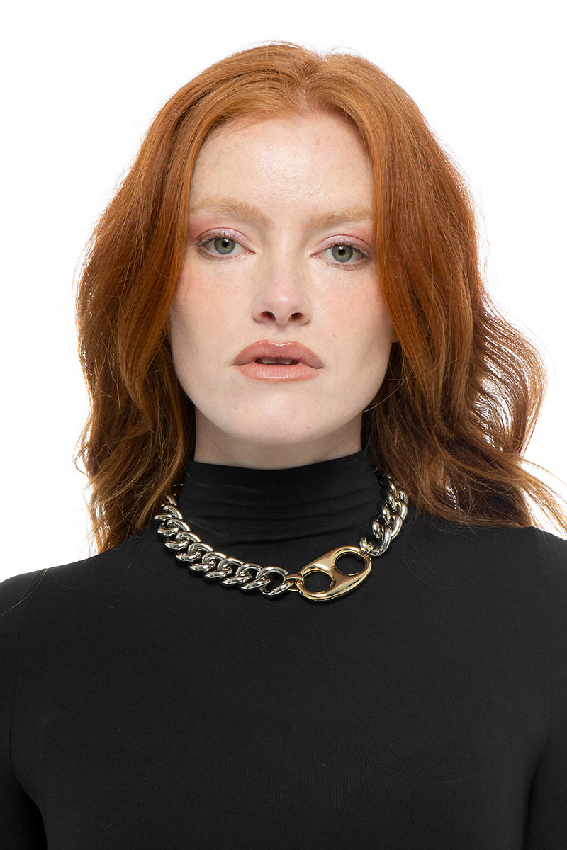 Silver Chloe necklace by Silvia Gnecchi featuring a delicate chain and minimalist pendant on a neutral background.