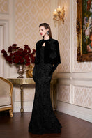Black princess line strapless gown with cape by I.H.F, elegant formal dress with flowing fabric and dramatic cape detail.