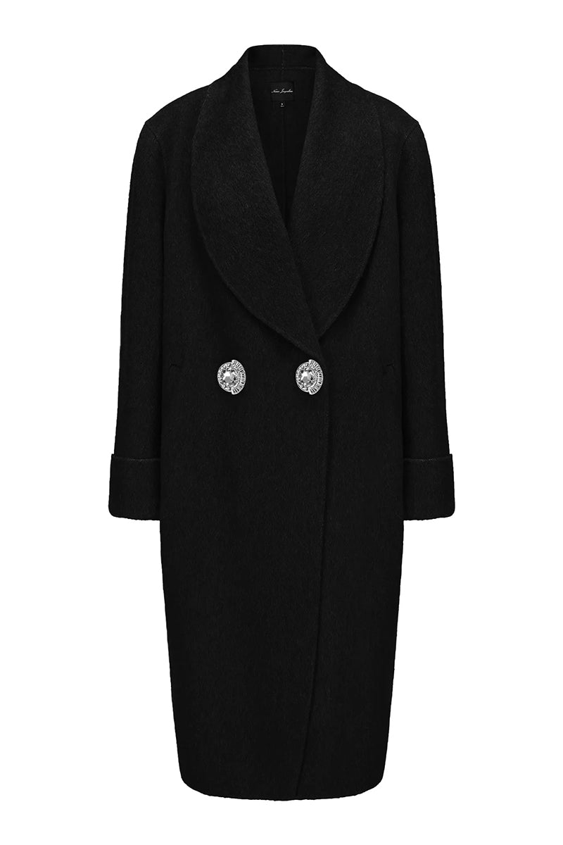 Nana Jacqueline Audrina black coat with tailored fit, shown hanging on a wooden hanger with a background of neutral tones.