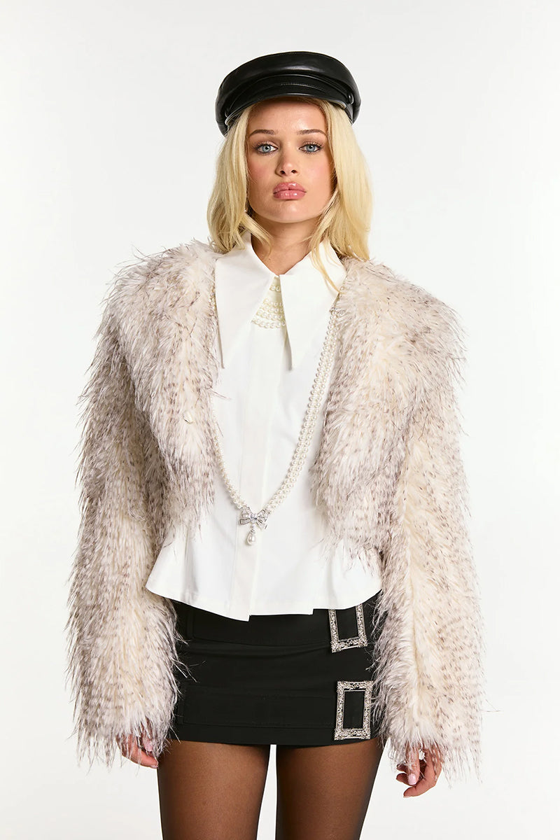 White Nana Jacqueline Mara fur coat with plush texture and elegant design, shown on a model.