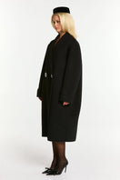 Black Audrina coat by Nana Jacqueline, stylish outerwear with a tailored fit and classic design, shown on a model.