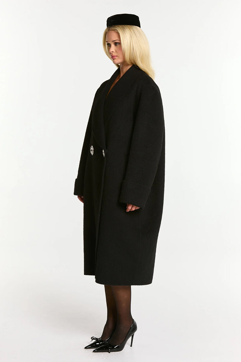 Black Audrina coat by Nana Jacqueline, stylish outerwear with a tailored fit and classic design, shown on a model.