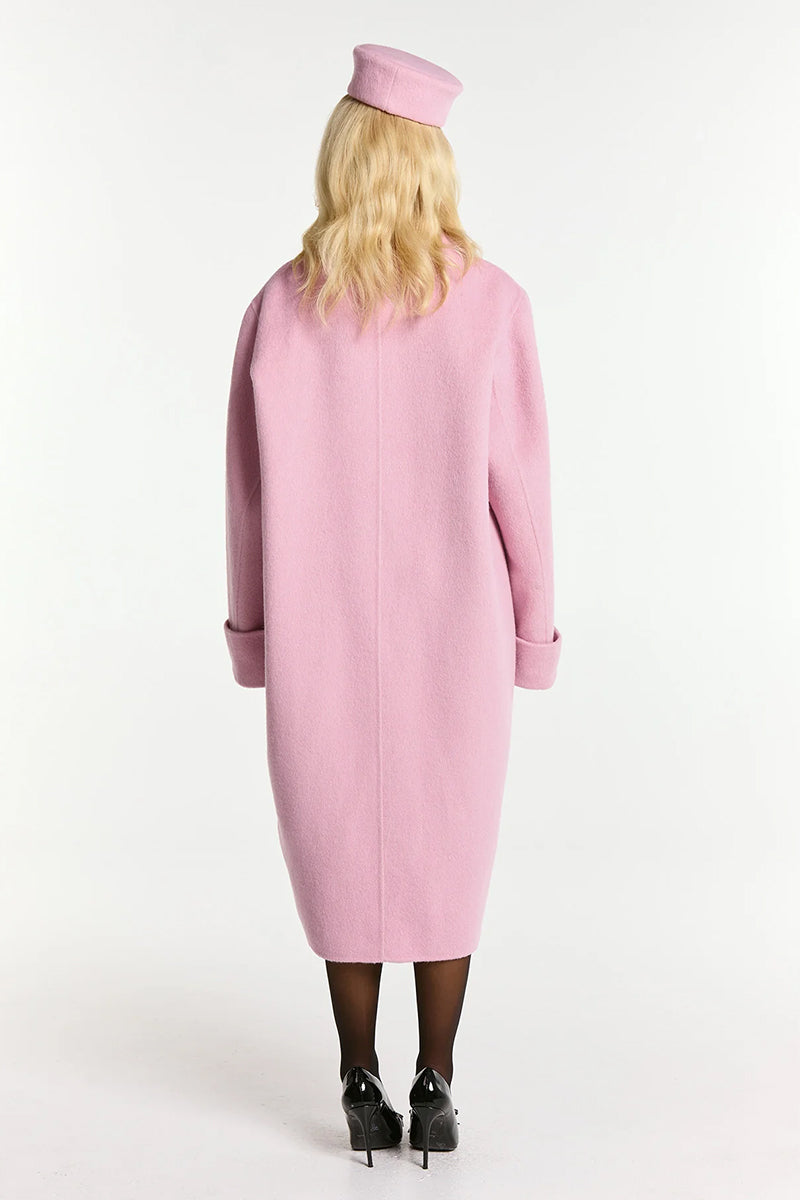 Nana Jacqueline Audrina pink coat displayed on a hanger, showcasing its stylish design and soft fabric.