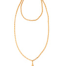 Gold VELA necklace by Silvia Gnecchi with a delicate chain and modern pendant, displayed on a neutral background.