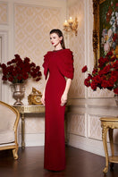 Elegant I.H.F round neckline column gown with a draped cape, featuring a sleek silhouette and sophisticated design.