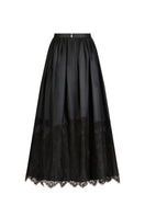 Black Fiorella maxi skirt by Scarlett Gasque, flowing design with a comfortable waistband, shown in a stylish fashion image.