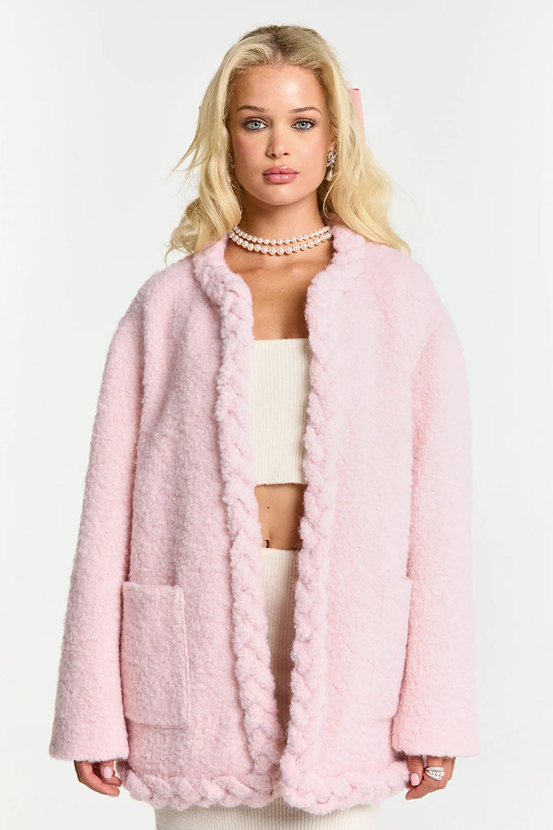 Pink TALIA coat by Nana Jacqueline, stylish and cozy outerwear with a tailored fit, displayed on a hanger.