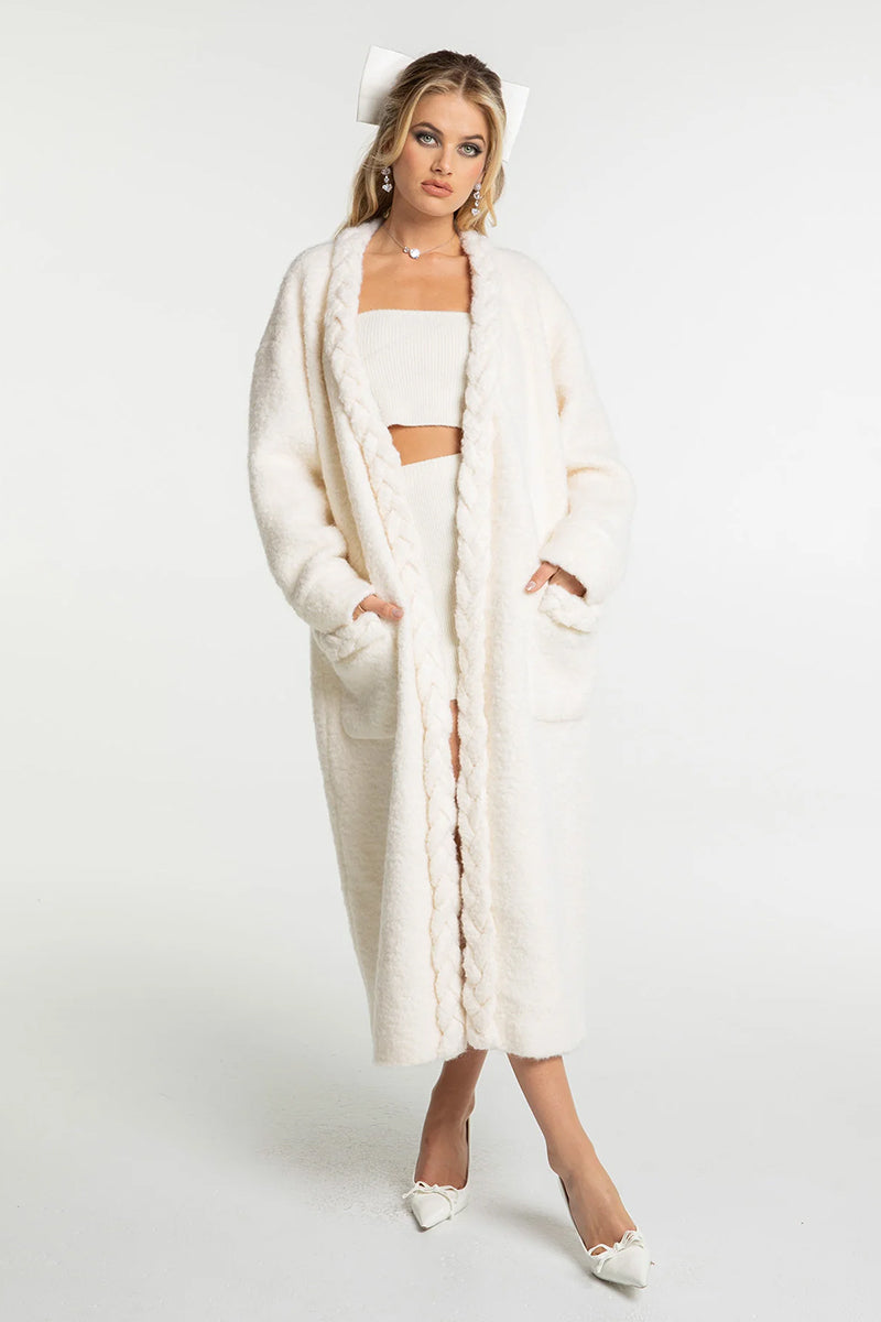 Off-white Nana Jacqueline Elsa coat displayed on a hanger, showcasing its elegant design and tailored fit.