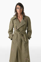 Yellow and pink gingham trench coat by Gvasalia featuring crystal bow accents and classic coat style.