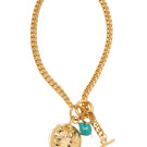 Gold Carrie necklace by Silvia Gnecchi featuring a delicate chain and minimalist pendant on a neutral background.