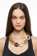 Silvia Gnecchi Polina Necklace featuring delicate chain and elegant pendant, displayed on a neutral background.
