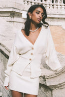Nana Jacqueline LIZA cardigan in a soft, neutral color, featuring a cozy knit with button closure and ribbed cuffs.