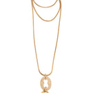 Silvia Gnecchi Bella in Gold and Rice Color necklace featuring delicate gold chain and rice-shaped pendant on a neutral background.