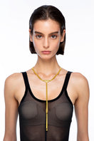 Gold necklace by Silvia Gnecchi featuring a sleek arrow pendant, styled on a delicate chain, perfect for elegant or casual wear.