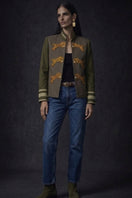 Nadya Shah olive hussar jacket in olive and khaki with detailed embroidery and structured design, displayed on a hanger.