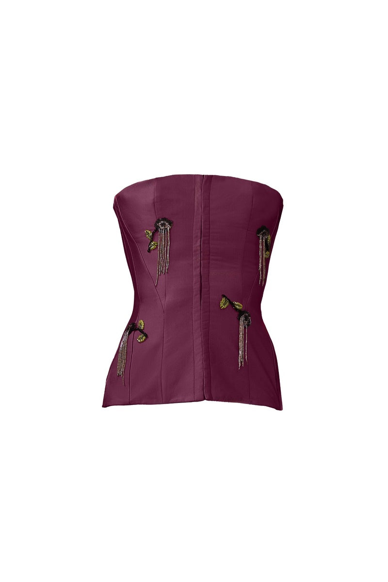 Purple flare corset top by Yassmin Saleh, featuring a fitted design with flare details and stylish neckline.