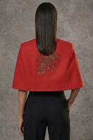 Nadya Shah Cape Éclat in Rouge, stylish jacket with vibrant red fabric, draped design, and elegant silhouette.