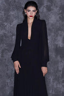 Black chiffon maxi gown with puffed sleeves and a corset-style bodice by CEM, flowing elegant evening dress.