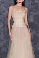 CEM nude sheer corset strap mesh floor-length gown, elegant maxi dress with fitted bodice and flowing skirt, perfect for formal events.