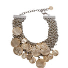 Silver and gold Candelaria necklace by Silvia Gnecchi featuring intricate design and elegant chain on a neutral background.