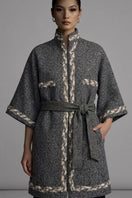 Nadya Shah Anya belted jacket in gray boucle fabric, stylish with a waist belt, displayed on a hanger.