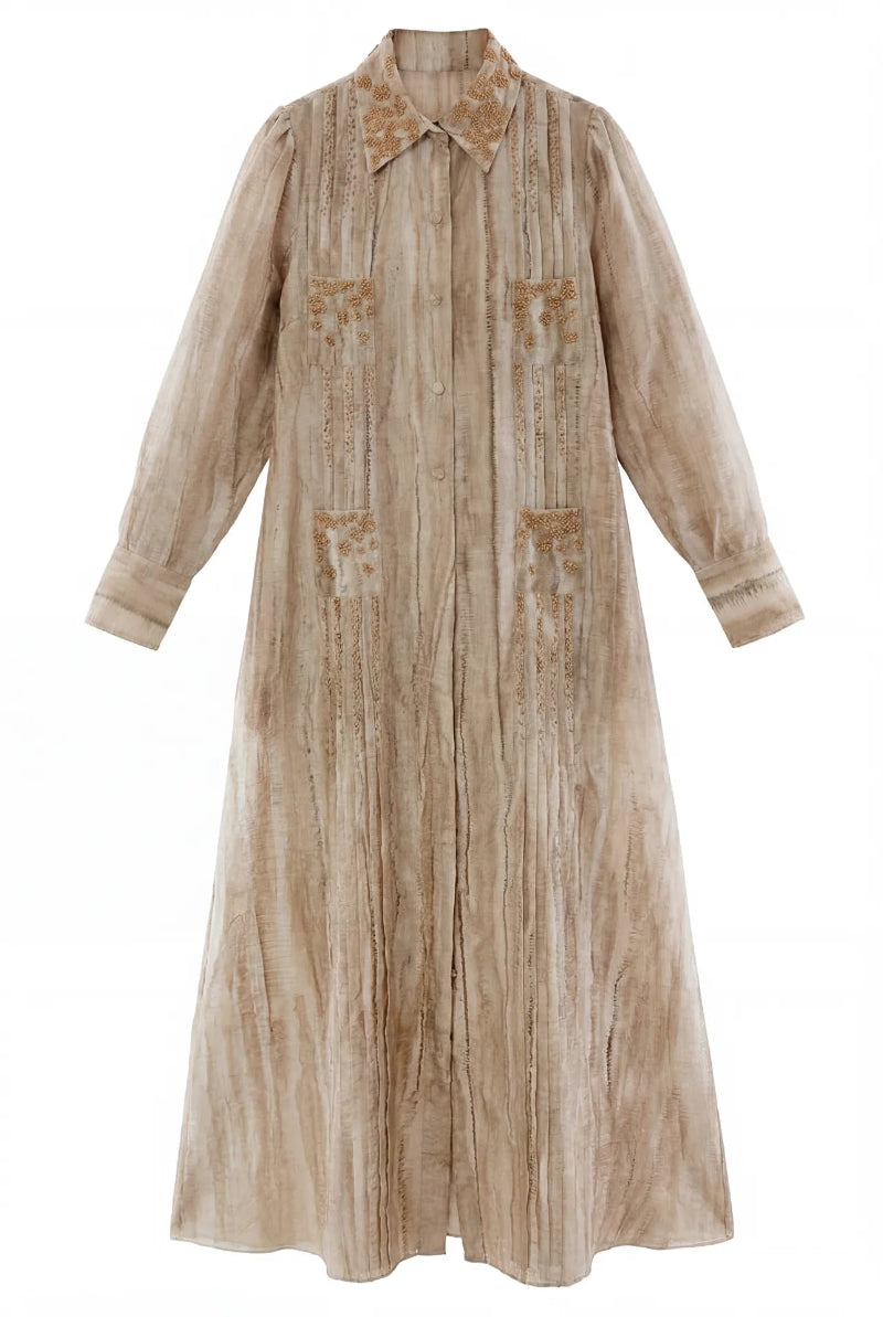 Embroidered Shatha Essa maxi shirt dress with detailed stitching, long sleeves, and a relaxed fit, displayed on a hanger.