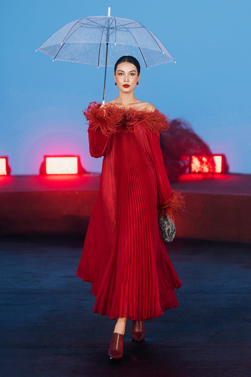 Red Valenciani midi dress with ostrich feather trim and pleated design, showcasing elegant fabric and stylish silhouette.