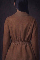 Nadya Shah Halycon wrap collar brown jacket displayed on a hanger, featuring a stylish design and soft fabric texture.