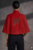 Nadya Shah Cape Éclat in Rouge, stylish jacket with vibrant red fabric and elegant design, displayed on a mannequin.
