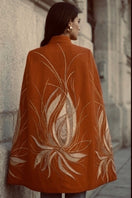 Nadya Shah Cape Solaris in Solar Amber, stylish jacket with warm, vibrant solar amber color, displayed on a model.