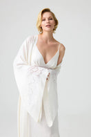 Bocan Couture Arabella cupro robe displayed on a hanger, featuring a sleek, elegant design with long sleeves and a smooth fabric finish.