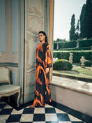 NiLuu Loren one-shoulder maxi dress in flowing fabric, elegant design with a fitted waist and asymmetrical neckline.