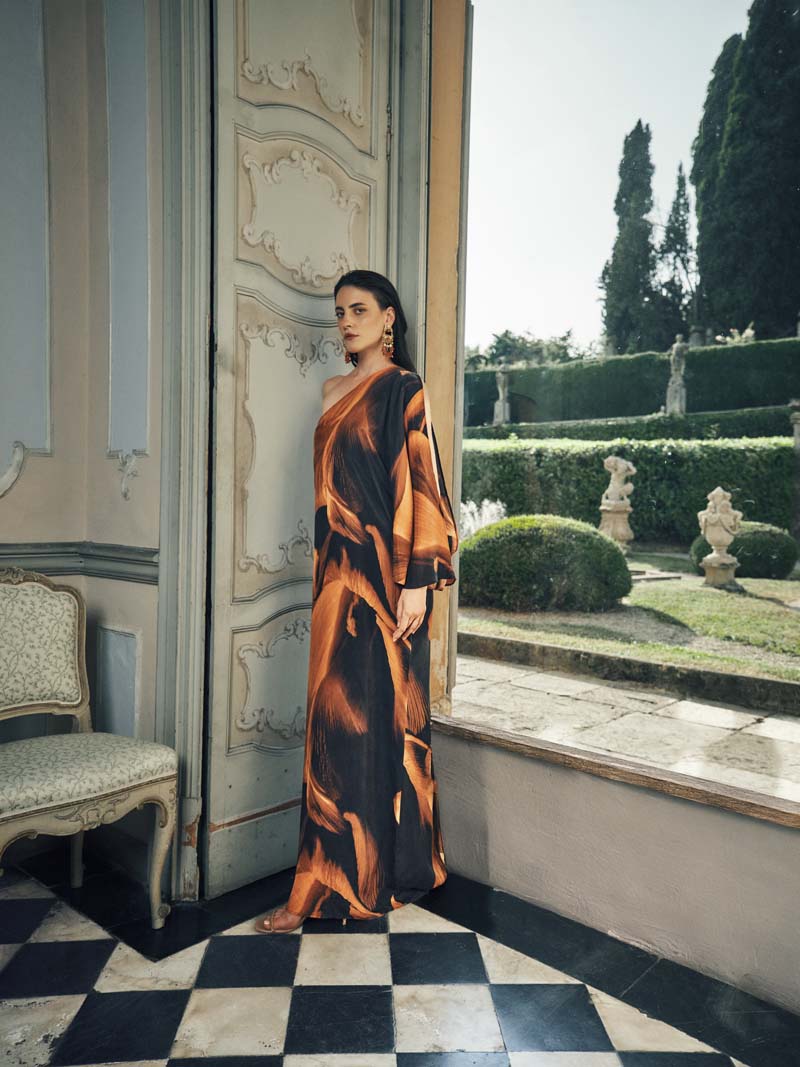 NiLuu Loren one-shoulder maxi dress in flowing fabric, elegant design with a fitted waist and asymmetrical neckline.