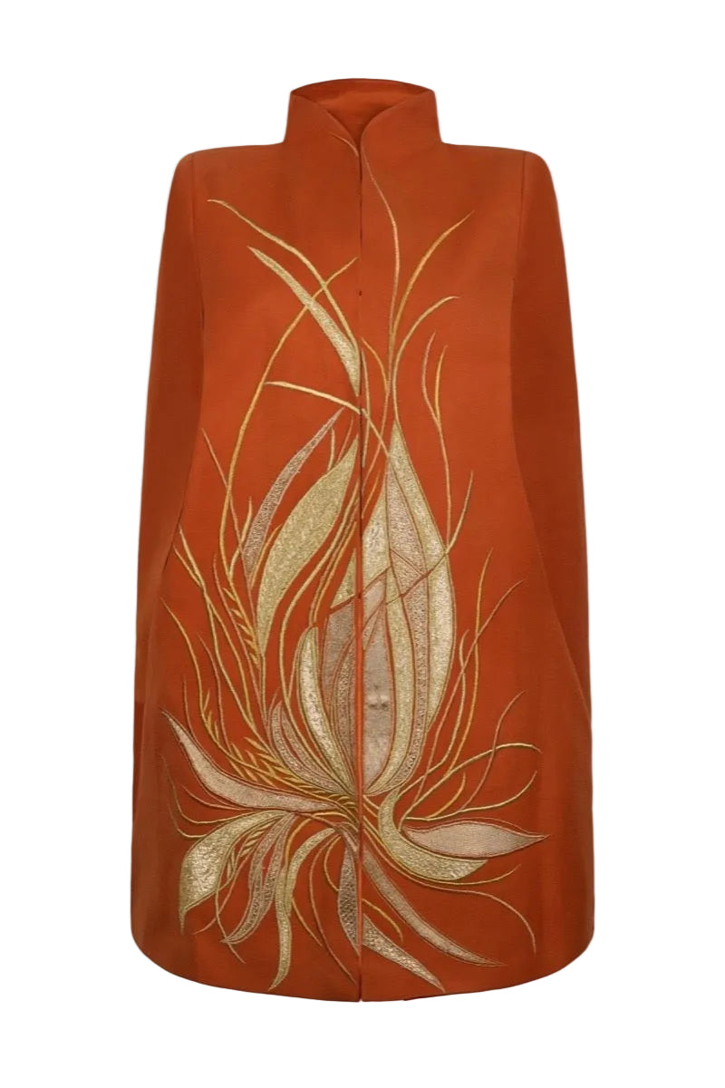 Nadya Shah Cape Solaris in Solar Amber jacket showcasing a stylish, lightweight design with warm solar amber color.