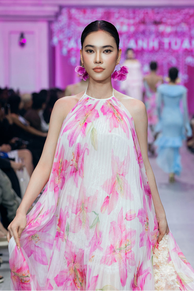 Valenciani multicolor halter neck pleated maxi dress displayed on a model, showcasing flowing fabric and vibrant pattern.