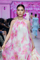 Valenciani multicolor halter neck pleated maxi dress displayed on a model, showcasing flowing fabric and vibrant pattern.