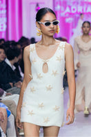 Valenciani Starfish mini dress in ivory, featuring a stylish sleeveless design and fitted silhouette, ideal for summer occasions.