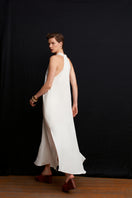 White Acaria Studio La Plage maxi dress featuring a flowing design and elegant neckline, perfect for casual or beachwear.