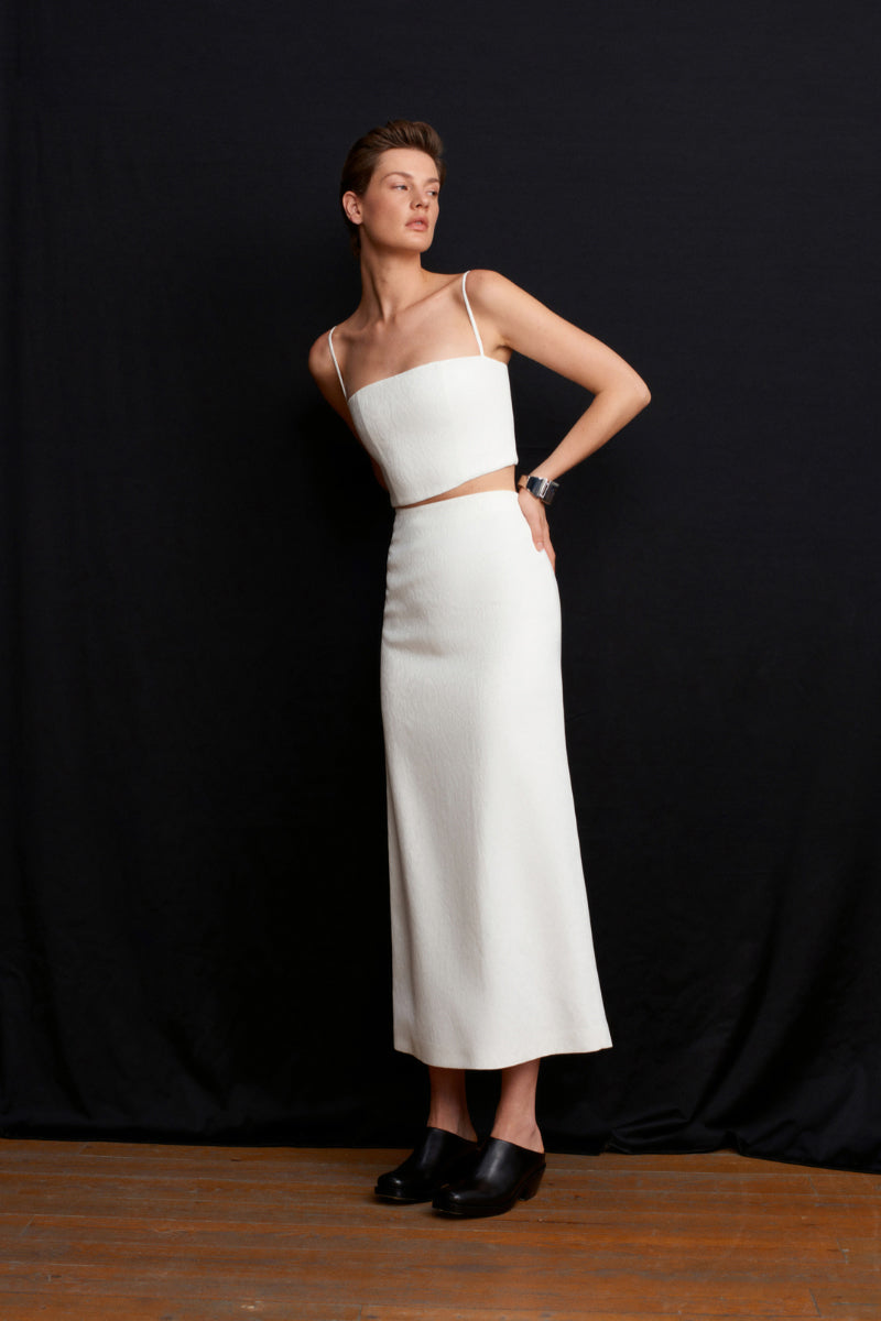 White Ancient Top by Acaria Studio featuring a relaxed fit and minimalist design, shown on a model.