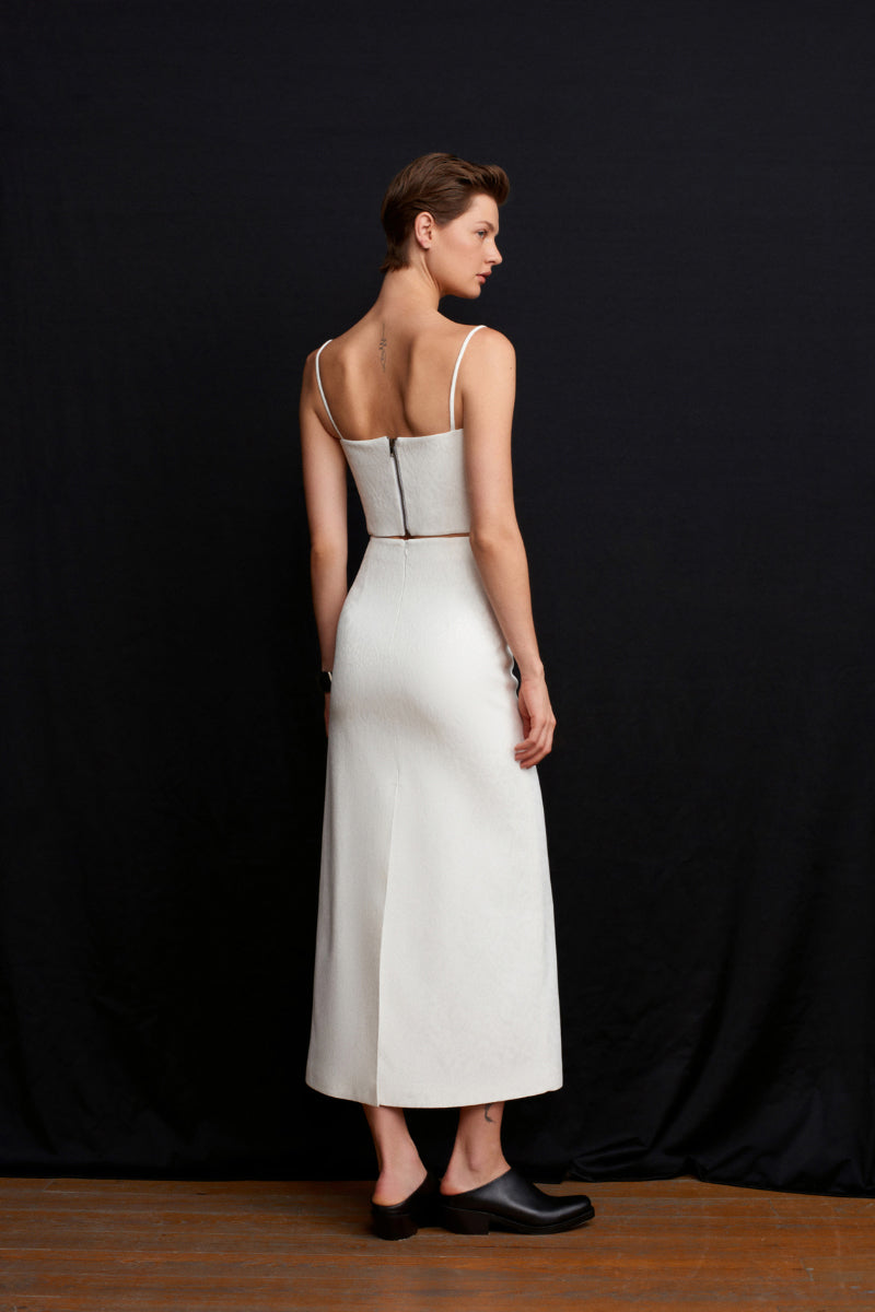White Ancient Top by Acaria Studio, stylish casual top with intricate details, shown on a model.