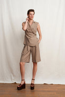 Beige TALIA tailored shorts by Acaria Studio, featuring a sleek fit and classic design, shown on a model.