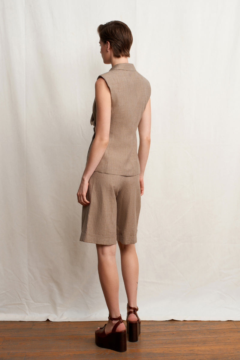 Beige TALIA tailored shorts by Acaria Studio, featuring a sleek fit and classic design, shown on a model.