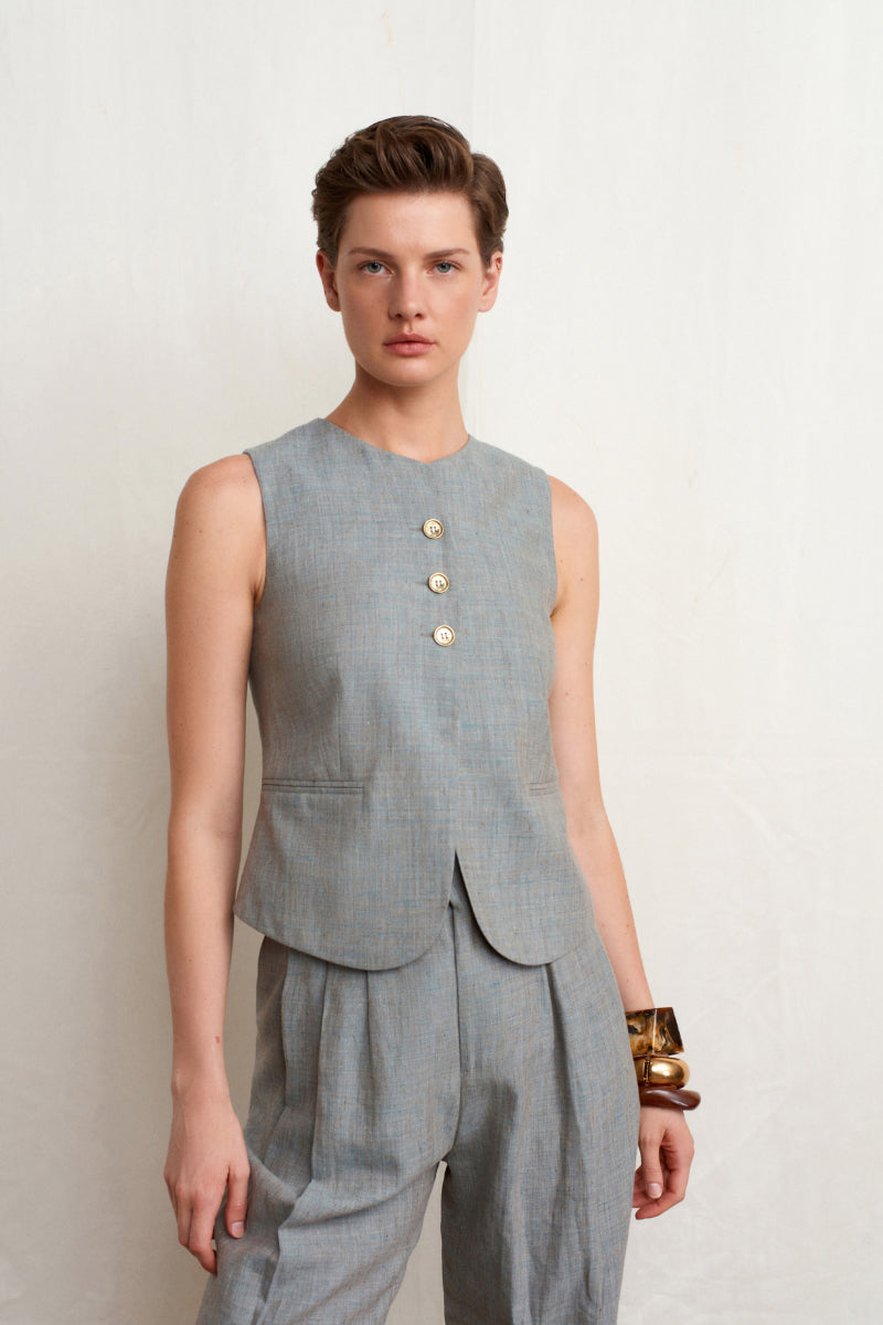Green melange linen vest from Acaria Studio's L'Ocean collection, showcasing a stylish, lightweight design with a natural fabric look.
