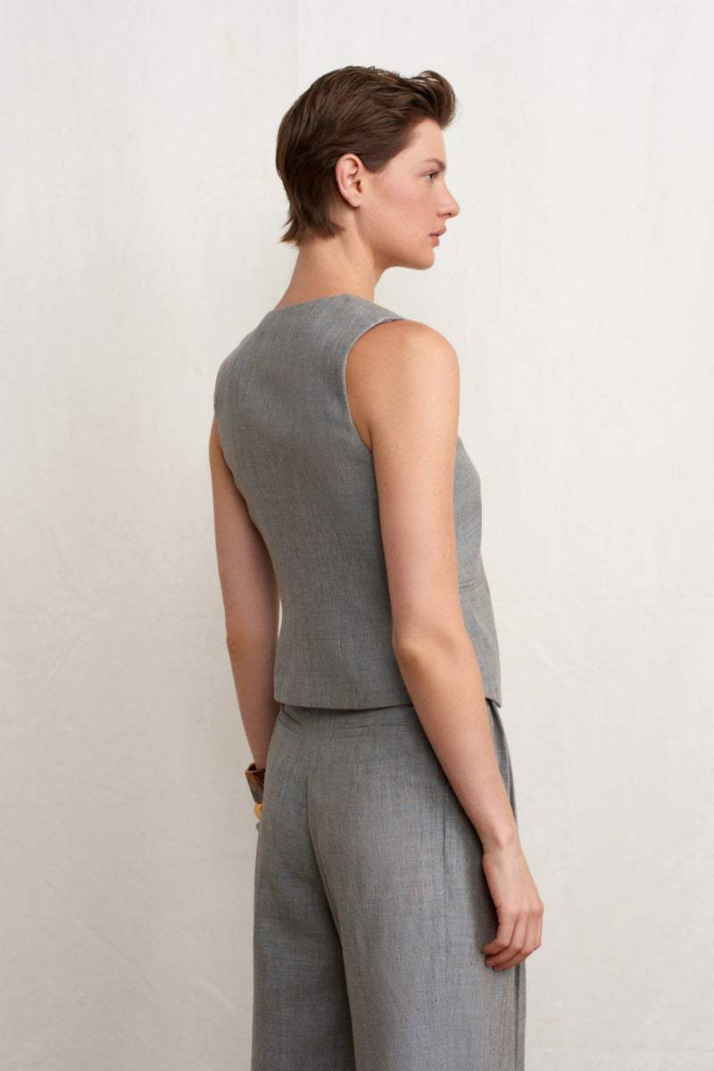 Green melange linen vest by Acaria Studio, featuring a lightweight, textured fabric and a stylish sleeveless design.