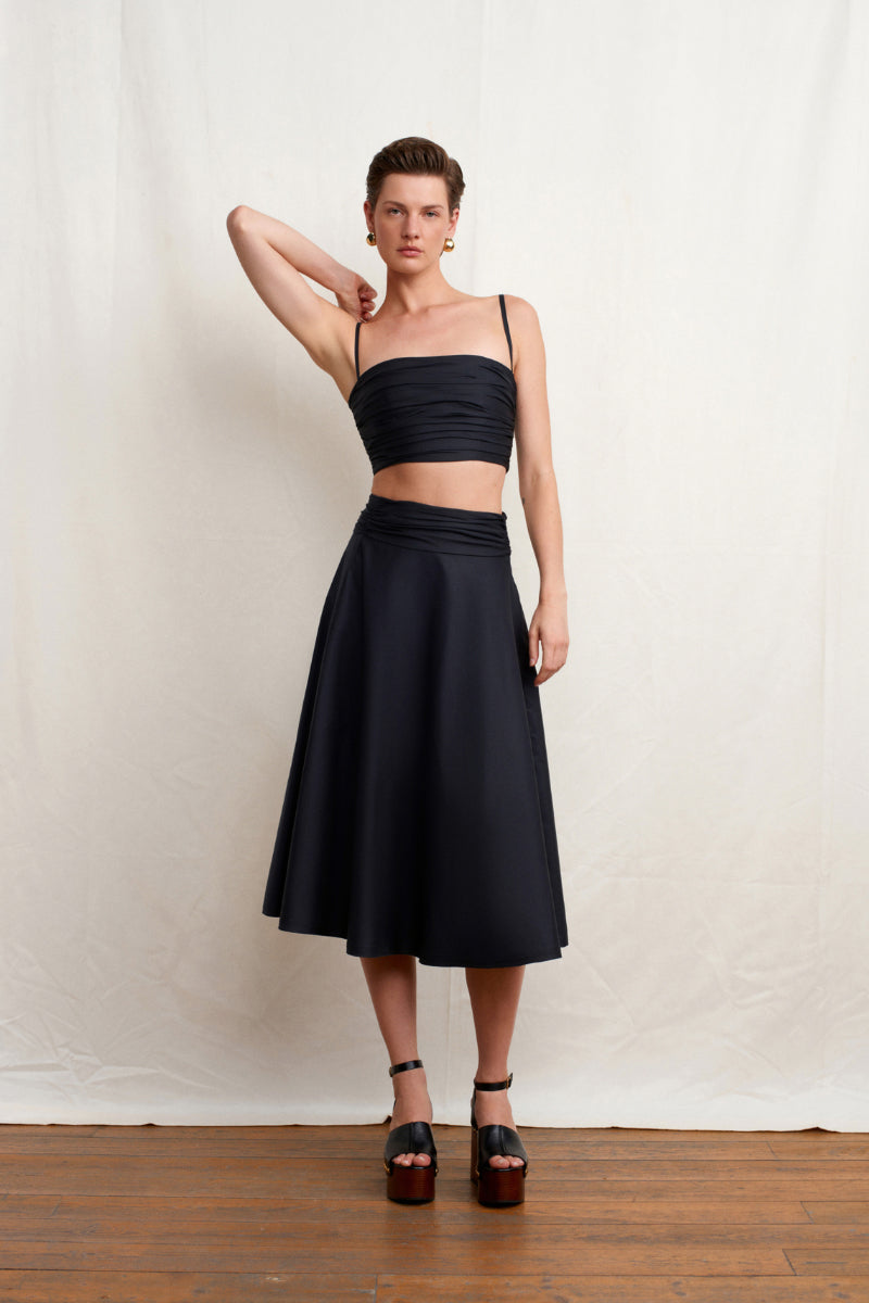 Black Wissy top by Acaria Studio featuring a stylish design, shown on a model with a focus on the fabric and fit.