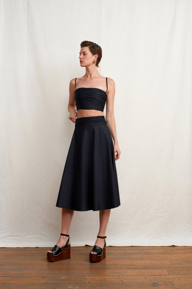 Black WISSY top by Acaria Studio featuring a stylish design, displayed on a neutral background with a focus on the fabric and fit.