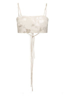 Beige Vaska crop top with short sleeves, styled casually on a hanger, showcasing its fitted design and soft fabric.