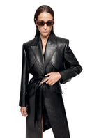 Black REIGN trench coat by MATTERS, stylish and tailored with classic lapels and button details, shown on a model.