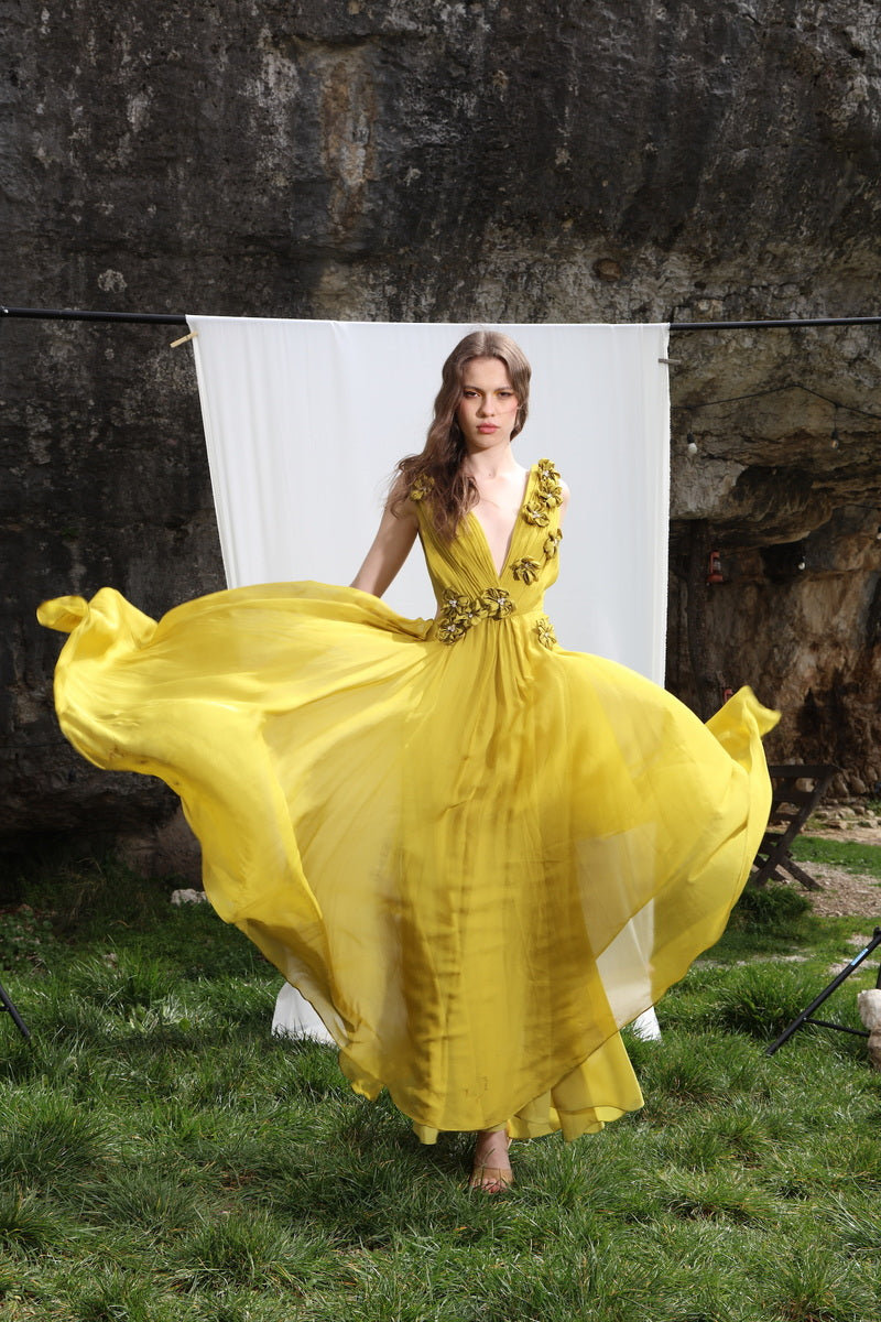 Aquarel Studio Poppy Dress gown with floral pattern, flowing fabric, and elegant design displayed on a mannequin.