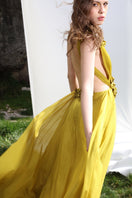 Aquarel Studio Poppy Dress gown with floral pattern, flowing fabric, and elegant design, displayed on a hanger.
